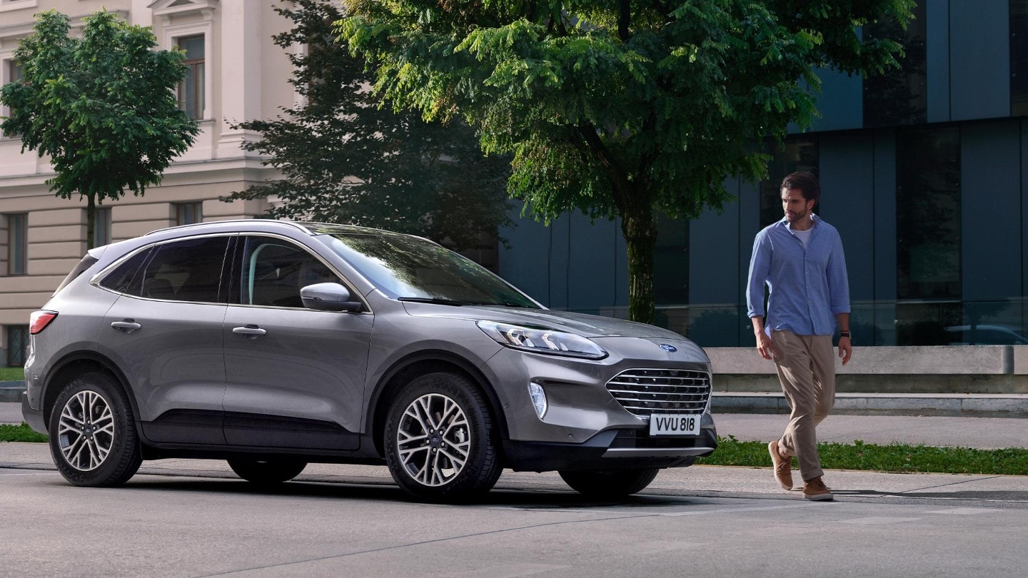 ford servicing eu man_and_kuga 16x9 2160x1215 Features Module man walking away from parked ford kuga